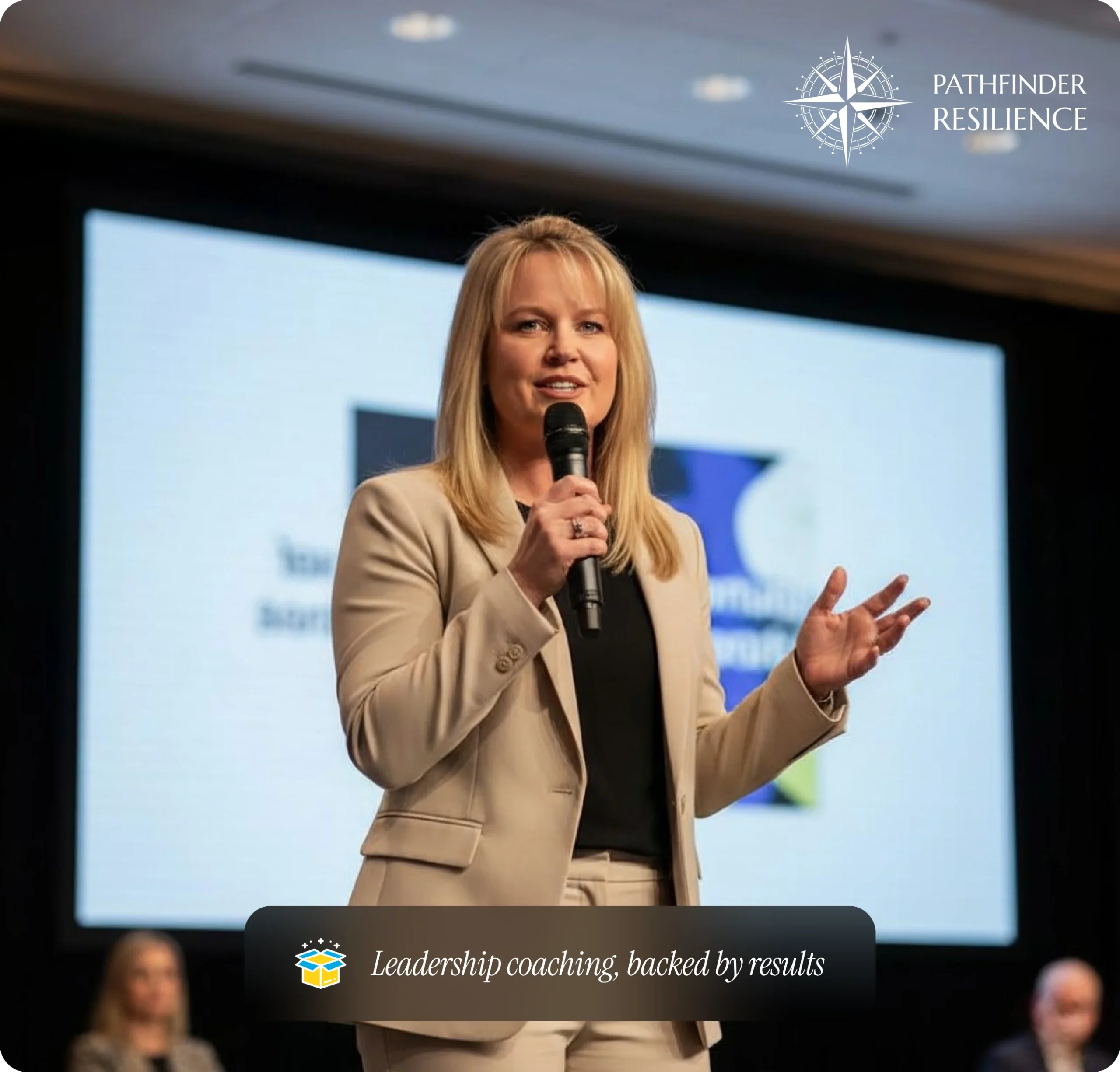 testimonials A woman in a tan suit speaking into a microphone in front of a screen with a slide behind her, with a white