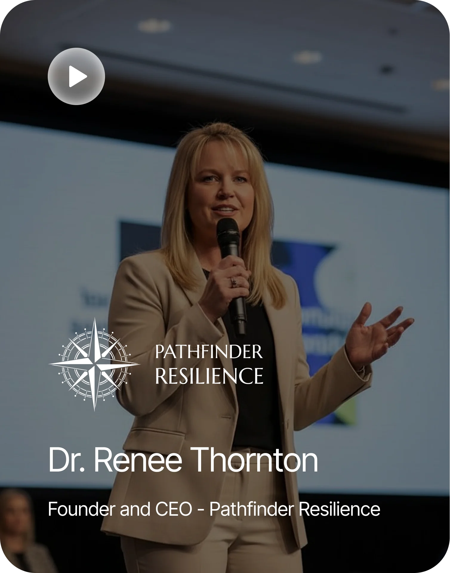 testimonials A woman in a tan suit speaking into a microphone, with a white logo and text overlayed on top