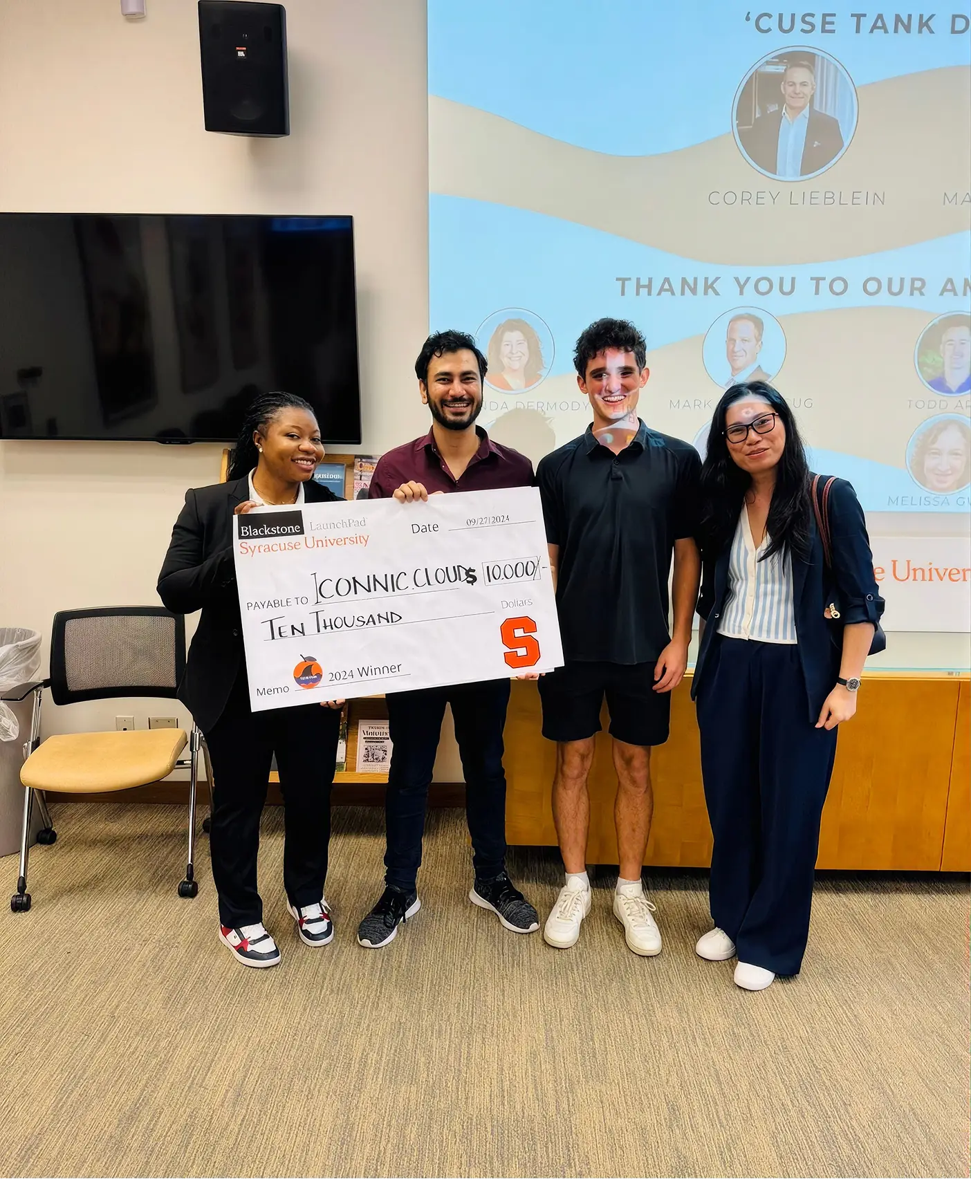 Iconnic.Cloud receiving a $10,000 check as a 2024 Cuse Tank winner