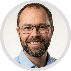 testimonials A man with a beard and glasses smiling at the camera, with a white background