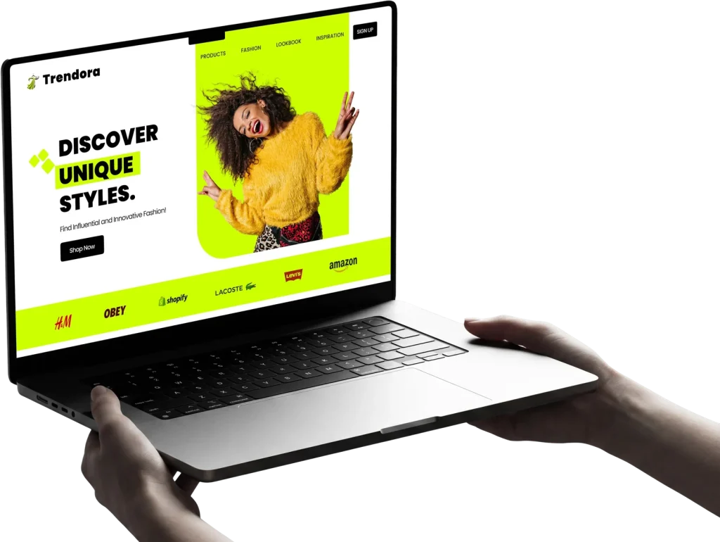 Laptop held in two hands showing a website design