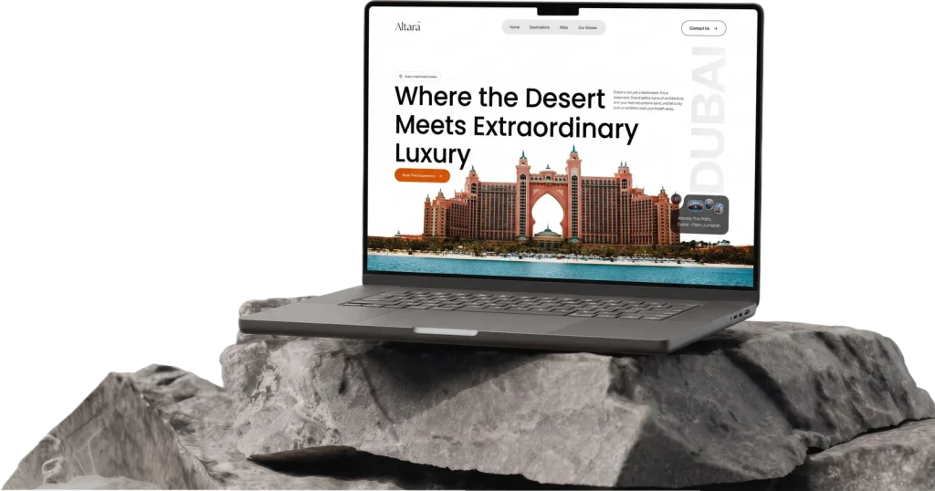 Laptop on a rock showing a website design